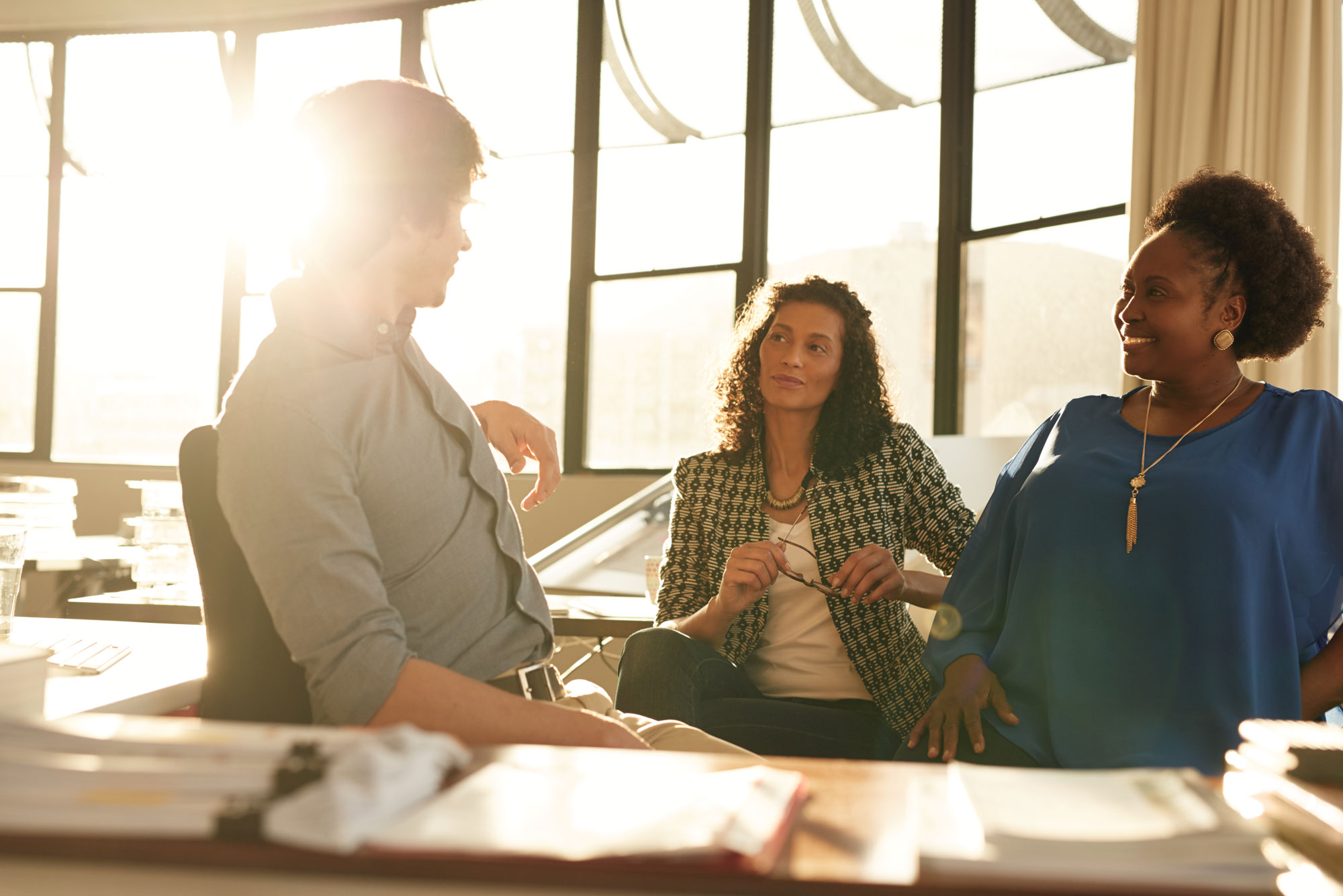 Group of people at a meeting in an office setting.